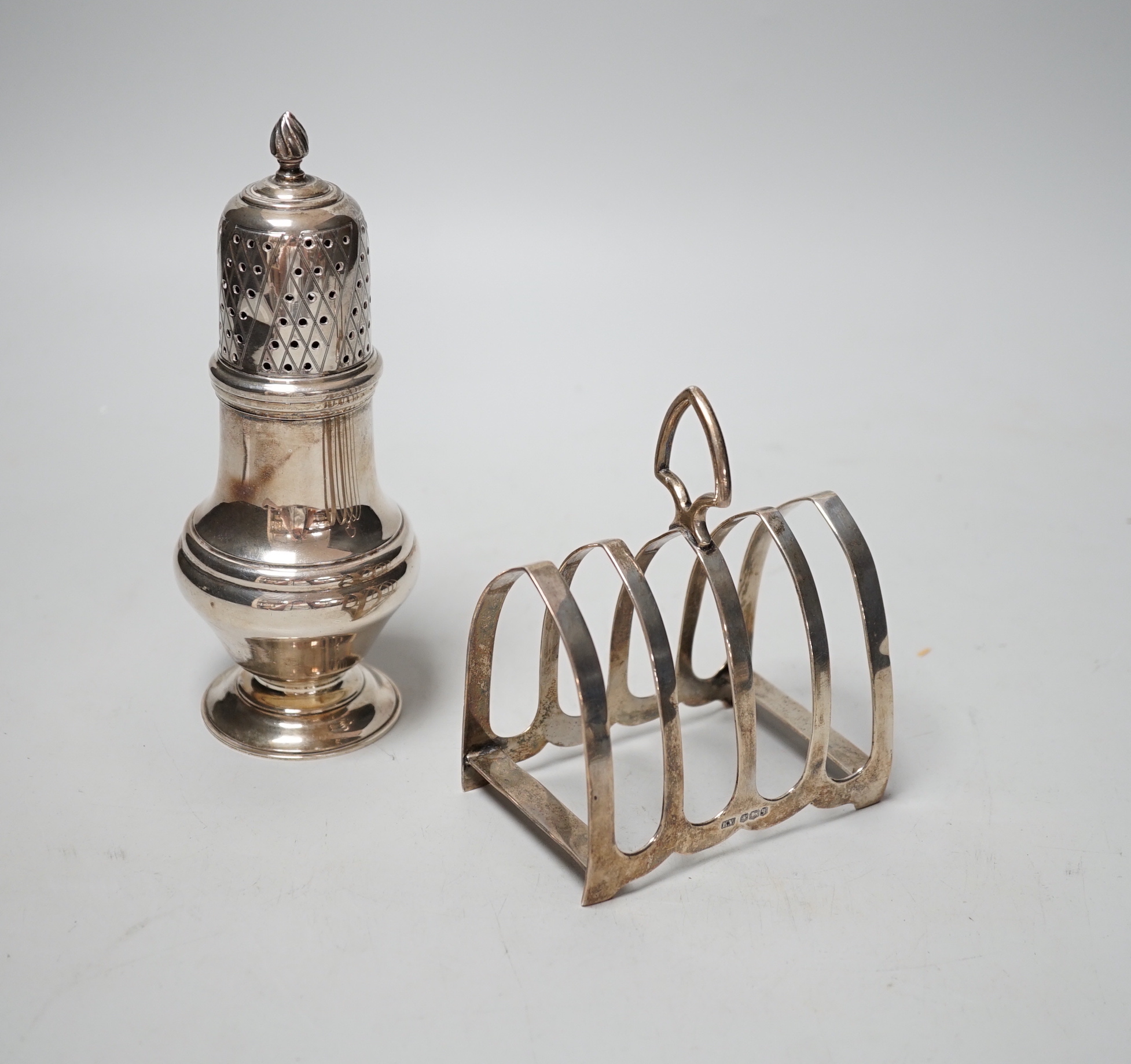 A modern silver sugar caster, 16.5cm and a George V silver toast rack, 8.7oz.